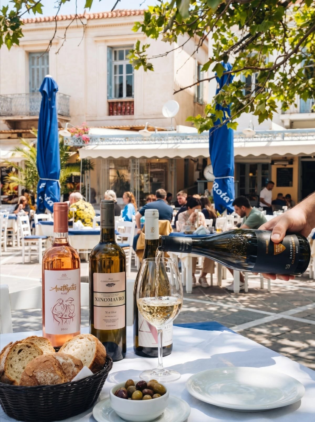 White wine service with bread and olives on the taverna terrace in Poros.